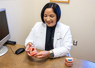 Dr Sanchez with models of teeth